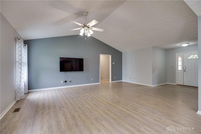 1360 Adamsmoor Dr, Waynesville, OH 45068 - unfurnished living room featuring a ceiling fan, wood finished floors, and vaulted ceiling