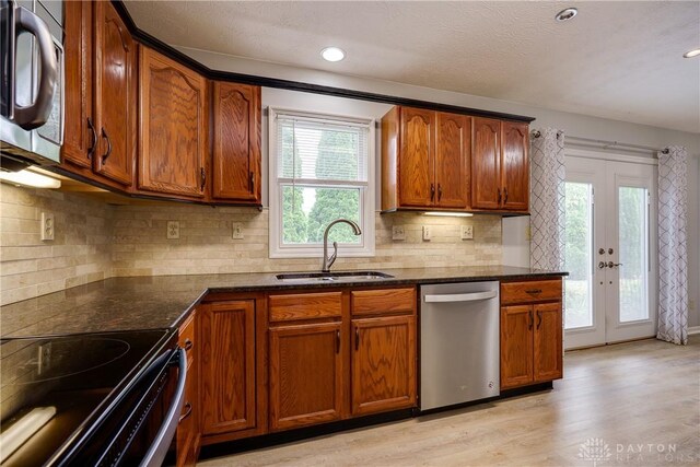 1360 Adamsmoor Dr, Waynesville, OH 45068 - kitchen with appliances with stainless steel finishes, dark stone counters, brown cabinetry, and recessed lighting
