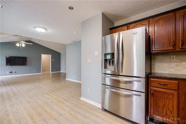 1360 Adamsmoor Dr, Waynesville, OH 45068 - kitchen with stainless steel refrigerator with ice dispenser, a ceiling fan, decorative backsplash, light wood-style flooring, and open floor plan