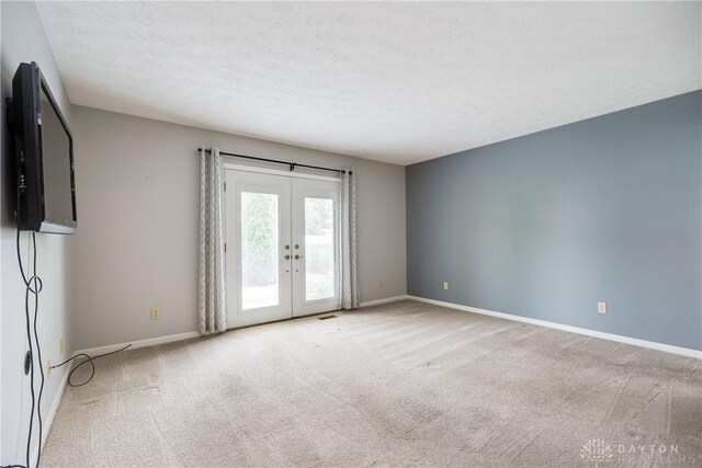 1360 Adamsmoor Dr, Waynesville, OH 45068 - unfurnished room featuring carpet flooring, french doors, and a textured ceiling