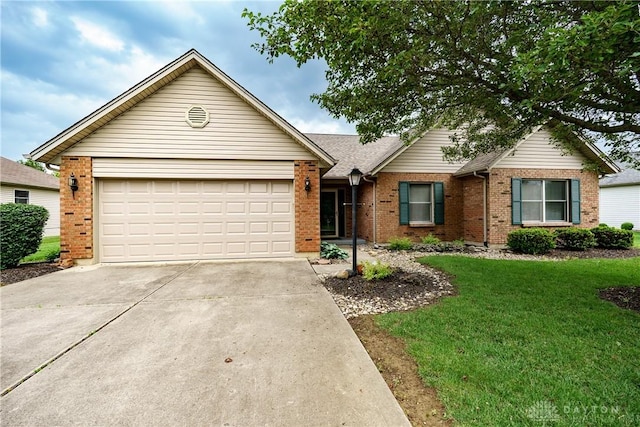 1360 Adamsmoor Dr, Waynesville, OH 45068 - single story home featuring brick siding, concrete driveway, a front lawn, and an attached garage