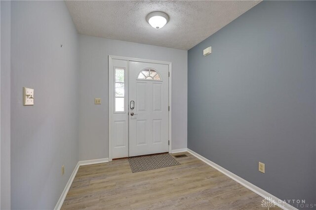 1360 Adamsmoor Dr, Waynesville, OH 45068 - entryway with a textured ceiling and wood finished floors
