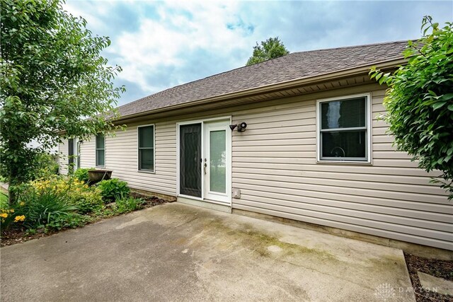1360 Adamsmoor Dr, Waynesville, OH 45068 - back of property with a patio area and roof with shingles