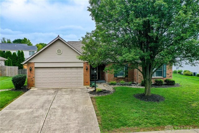 1360 Adamsmoor Dr, Waynesville, OH 45068 - view of front of house with a garage, brick siding, and concrete driveway