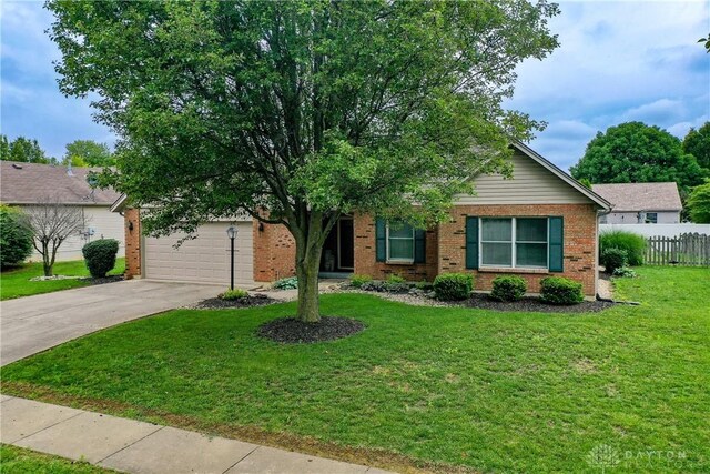 1360 Adamsmoor Dr, Waynesville, OH 45068 - view of front facade featuring concrete driveway, brick siding, and an attached garage