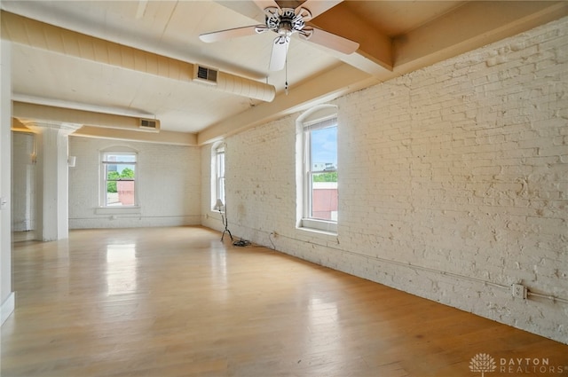 18 S Saint Clair St Unit 203, Dayton, OH 45402 - unfurnished room featuring ceiling fan, wood finished floors, brick wall, and beamed ceiling