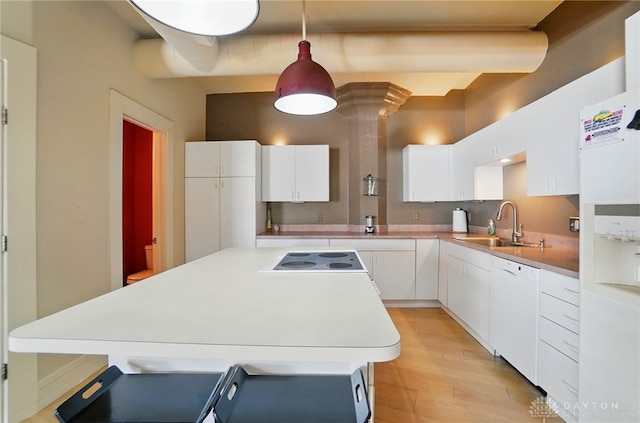 18 S Saint Clair St Unit 203, Dayton, OH 45402 - kitchen featuring white appliances, light wood-type flooring, white cabinetry, a kitchen island, and light countertops