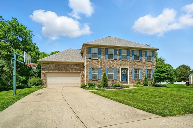 1510 Ash Ridge Ct, Vandalia, OH 45377 - colonial home featuring a front yard, a garage, driveway, and brick siding