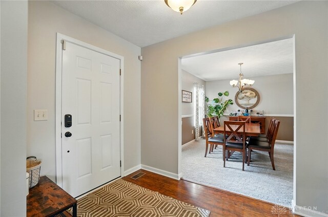 1510 Ash Ridge Ct, Vandalia, OH 45377 - foyer featuring dark wood finished floors and a chandelier