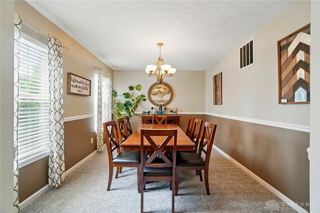1510 Ash Ridge Ct, Vandalia, OH 45377 - carpeted dining area featuring a chandelier and baseboards