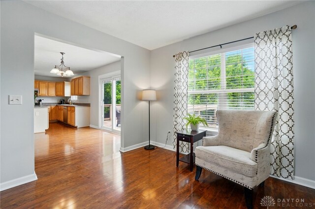 1510 Ash Ridge Ct, Vandalia, OH 45377 - sitting room featuring a chandelier, plenty of natural light, and wood finished floors
