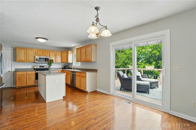1510 Ash Ridge Ct, Vandalia, OH 45377 - kitchen featuring stainless steel appliances, plenty of natural light, a chandelier, and a center island