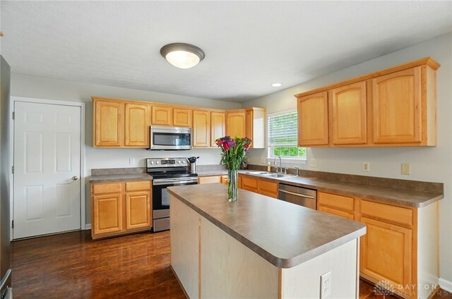 1510 Ash Ridge Ct, Vandalia, OH 45377 - kitchen with stainless steel appliances, light brown cabinetry, dark wood-style flooring, a kitchen island, and recessed lighting