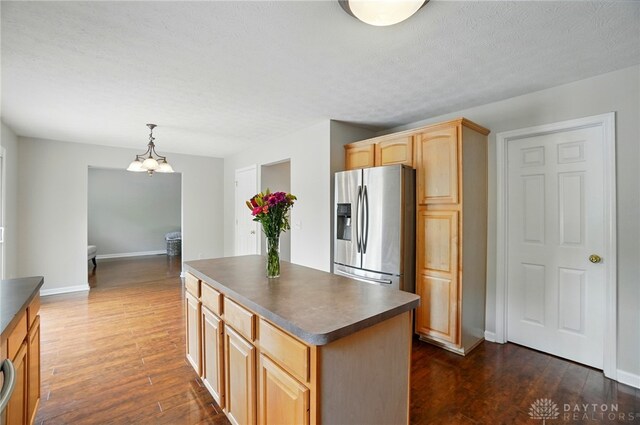 1510 Ash Ridge Ct, Vandalia, OH 45377 - kitchen featuring stainless steel fridge, dark countertops, dark wood-style flooring, and a center island