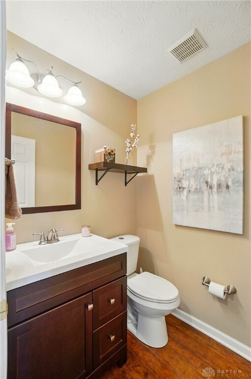 1510 Ash Ridge Ct, Vandalia, OH 45377 - bathroom featuring vanity, wood finished floors, and a textured ceiling