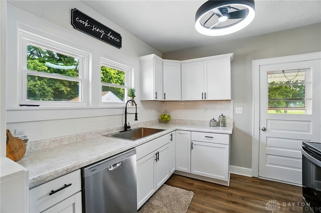 2003 Lowell St, Middletown, OH 45042 - kitchen with stainless steel dishwasher, electric range oven, backsplash, light countertops, and white cabinets