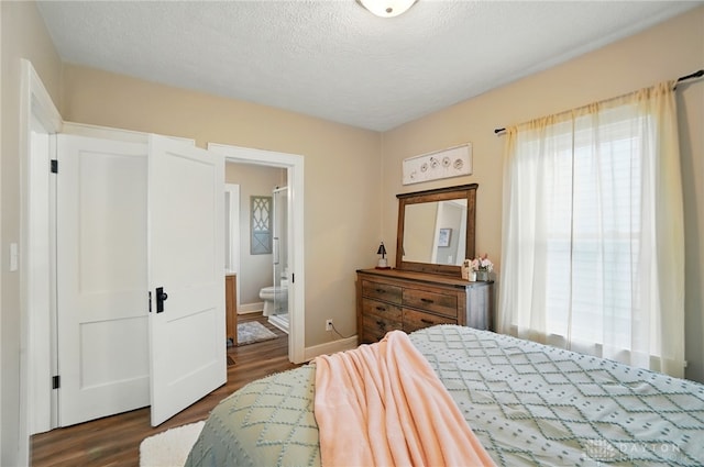2003 Lowell St, Middletown, OH 45042 - bedroom with dark wood finished floors, ensuite bath, and a textured ceiling