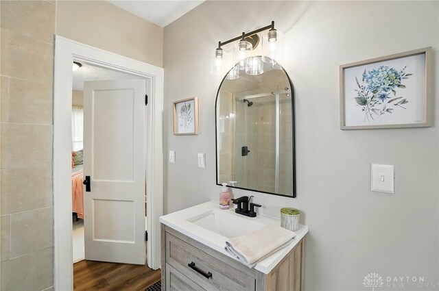 2003 Lowell St, Middletown, OH 45042 - bathroom with vanity, wood finished floors, and a tile shower