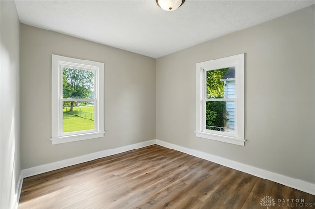 2003 Lowell St, Middletown, OH 45042 - empty room featuring healthy amount of natural light and wood finished floors