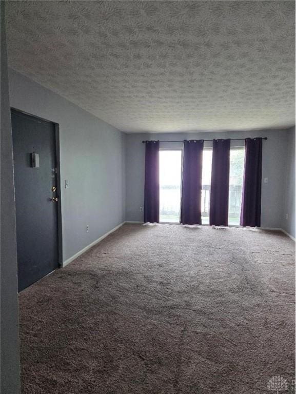 5660 Coach Dr Unit C, Dayton, OH 45440 - carpeted empty room featuring a textured ceiling and baseboards