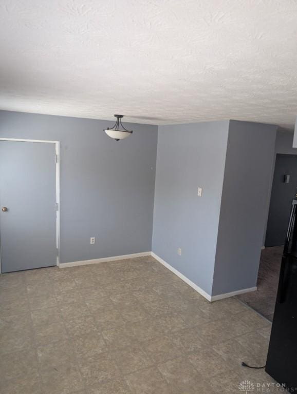 5660 Coach Dr Unit C, Dayton, OH 45440 - spare room with baseboards and a textured ceiling