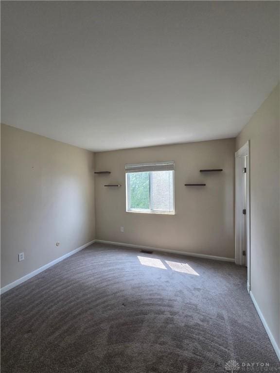 5660 Coach Dr Unit C, Dayton, OH 45440 - empty room with carpet floors and baseboards
