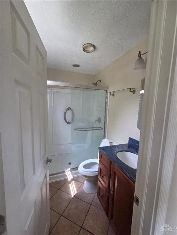 5660 Coach Dr Unit C, Dayton, OH 45440 - bathroom featuring a shower stall, vanity, tile patterned floors, and a textured ceiling