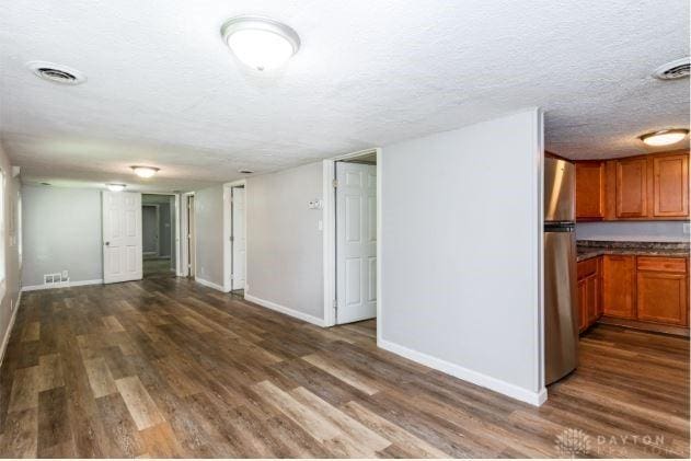 7293 Ellenridge Dr, Franklin, OH 45005 - unfurnished living room with a textured ceiling and dark wood finished floors
