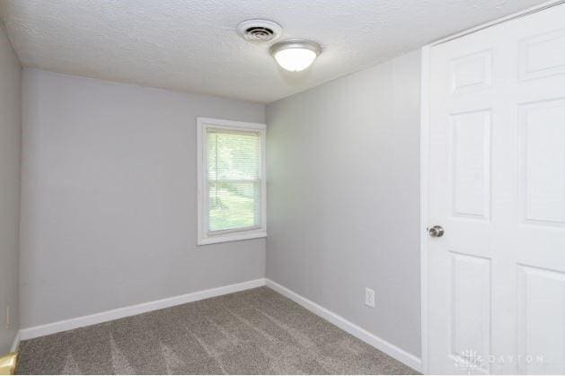 7293 Ellenridge Dr, Franklin, OH 45005 - carpeted empty room with a textured ceiling and baseboards