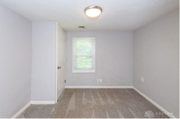 7293 Ellenridge Dr, Franklin, OH 45005 - carpeted empty room featuring a textured ceiling and baseboards