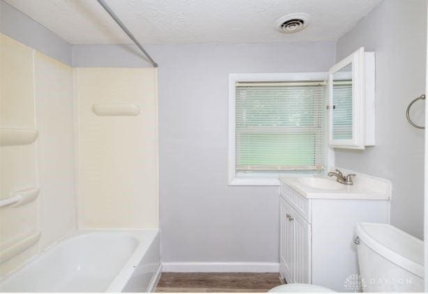7293 Ellenridge Dr, Franklin, OH 45005 - full bath featuring vanity, wood finished floors, shower / bathtub combination, and a textured ceiling