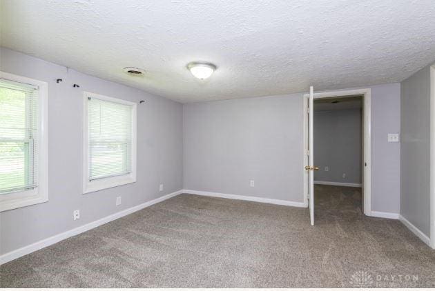 7293 Ellenridge Dr, Franklin, OH 45005 - carpeted spare room featuring a textured ceiling and plenty of natural light