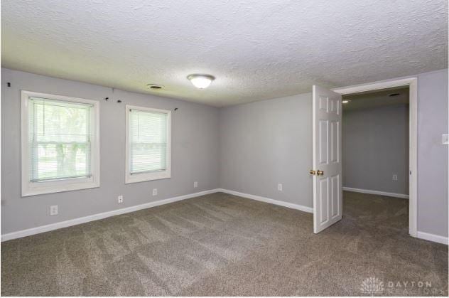 7293 Ellenridge Dr, Franklin, OH 45005 - empty room featuring carpet flooring and a textured ceiling