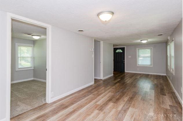 7293 Ellenridge Dr, Franklin, OH 45005 - spare room featuring wood finished floors, plenty of natural light, and a textured ceiling