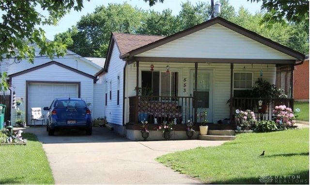553 Osborn Ave, Fairborn, OH 45324 - view of front of property featuring covered porch, driveway, a front lawn, and a garage