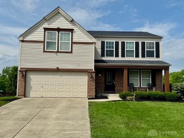 6460 Woodcreek Dr, Middletown, OH 45042 - view of front of home with a garage, concrete driveway, a front yard, and brick siding
