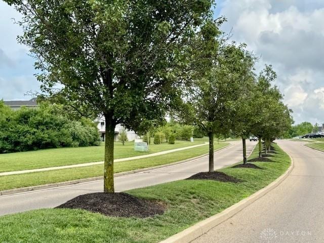 6460 Woodcreek Dr, Middletown, OH 45042 - view of asphalt road with curbs and sidewalks