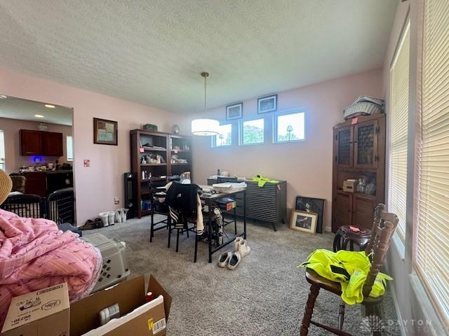 6460 Woodcreek Dr, Middletown, OH 45042 - dining area featuring carpet and a textured ceiling