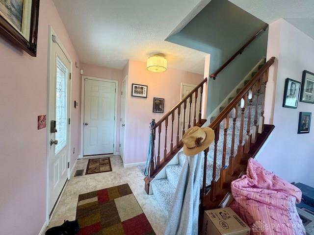 6460 Woodcreek Dr, Middletown, OH 45042 - entrance foyer featuring stairway and baseboards