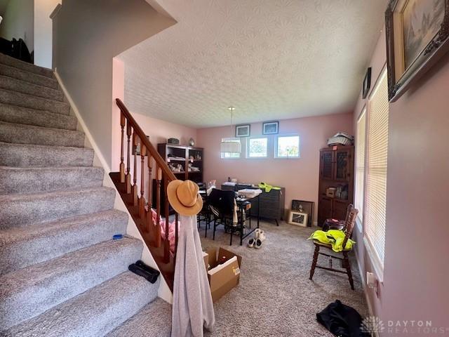 6460 Woodcreek Dr, Middletown, OH 45042 - stairway with a textured ceiling and carpet flooring