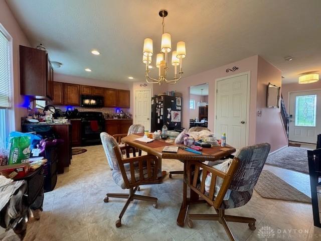 6460 Woodcreek Dr, Middletown, OH 45042 - dining room featuring a chandelier and recessed lighting