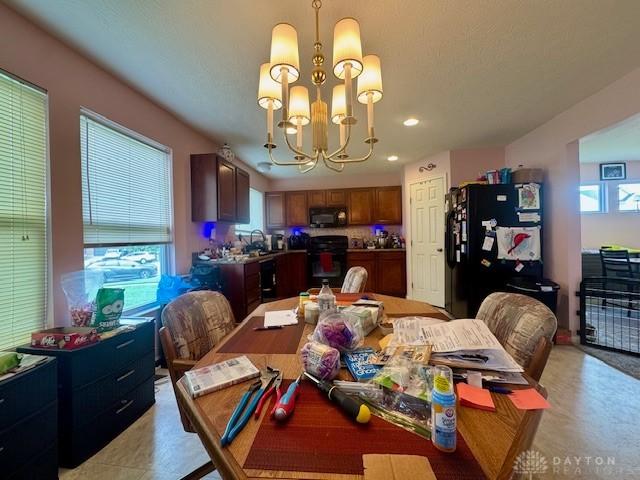 6460 Woodcreek Dr, Middletown, OH 45042 - dining area with a chandelier and recessed lighting