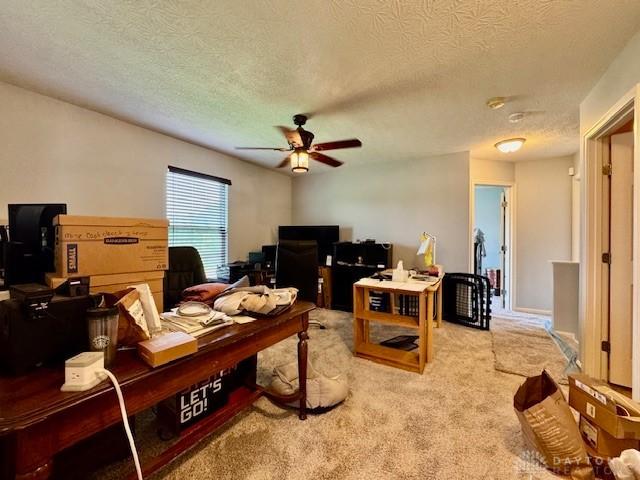 6460 Woodcreek Dr, Middletown, OH 45042 - living room featuring a desk, a ceiling fan, light colored carpet, and a textured ceiling