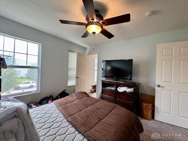 6460 Woodcreek Dr, Middletown, OH 45042 - carpeted bedroom with a textured ceiling and a ceiling fan