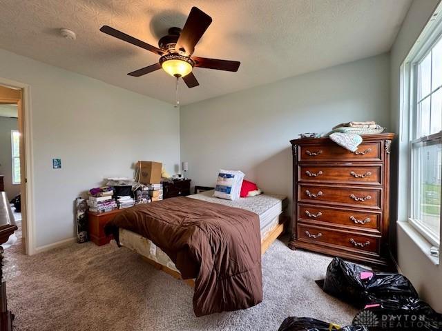 6460 Woodcreek Dr, Middletown, OH 45042 - carpeted bedroom featuring multiple windows and a ceiling fan