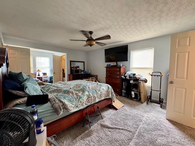 6460 Woodcreek Dr, Middletown, OH 45042 - bedroom featuring carpet floors, a ceiling fan, and a textured ceiling