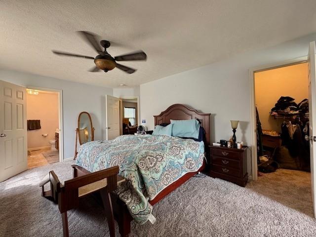 6460 Woodcreek Dr, Middletown, OH 45042 - carpeted bedroom featuring a walk in closet, ensuite bathroom, a closet, and ceiling fan
