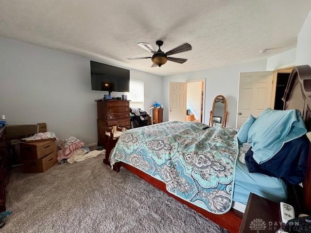 6460 Woodcreek Dr, Middletown, OH 45042 - carpeted bedroom with a textured ceiling and ceiling fan