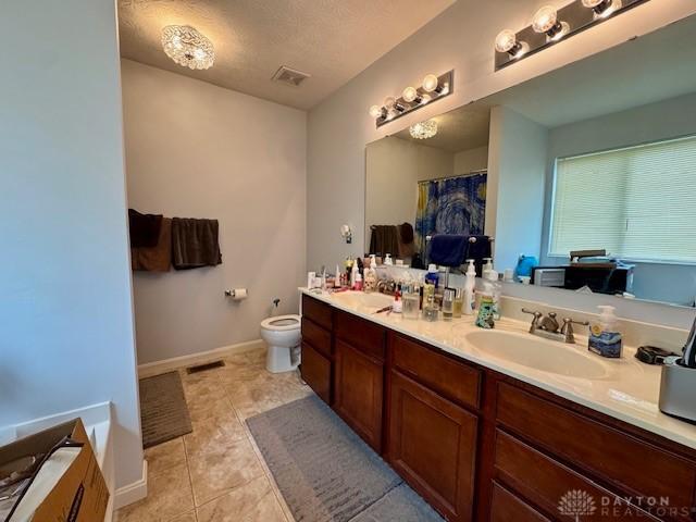 6460 Woodcreek Dr, Middletown, OH 45042 - bathroom featuring double vanity, tile patterned flooring, and a shower with shower curtain
