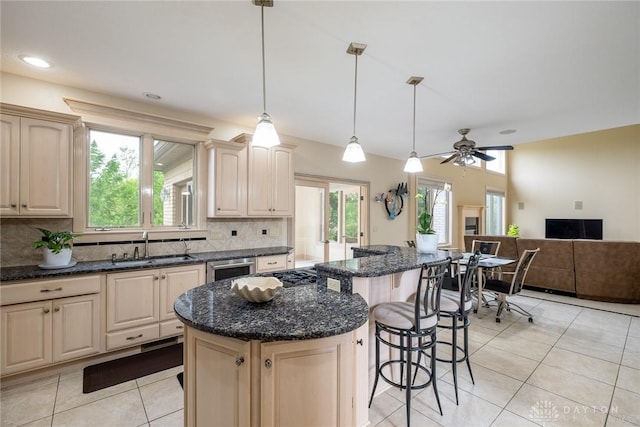 337 Yorkshire Ln, Beavercreek Twp, OH 45385 - kitchen with tasteful backsplash, light tile patterned floors, plenty of natural light, and a kitchen bar
